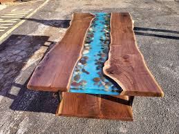 An epoxy river table is created by pouring a 'river' of epoxy into a prepared wooden frame so the epoxy runs between two pieces of wood or around a single piece of wood (as created in this guide). Beautiful Epoxy Resin River Waterfall Tables Crafted In Nj Resin Table Olive Wood Clear Epoxy Resin