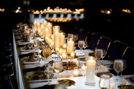 Long Banquet Tables Covered In Votive Candles On Mirrored Pedestals Lent An Intima Candle Wedding Decor Wedding Reception Candles Long Wedding Reception Tables