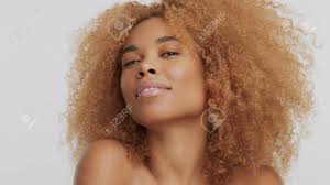 This hairstyle is being a perfect choice for those girls who are born with natural curly hair. Mixed Race Black Blonde Model With Curly Hair With Chin Uo Head Watching To The Camera Stock Photo Picture And Royalty Free Image Image 110741630