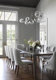 Ten Sleek Gray Dining Chairs Surround A Brown Wood Dining Table Placed On A Wood Herringbone Floor Bene Dining Room Small Dining Room Makeover Grey Dining Room