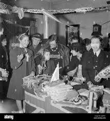 BWRS CHRISTMAS GIFTS DISTRIBUTED TO LONDON'S EAST ENDERS: AMERICAN AID TO  THE CANNING TOWN SETTLEMENT, LONDON, ENGLAND, UK, DECEMBER 1944