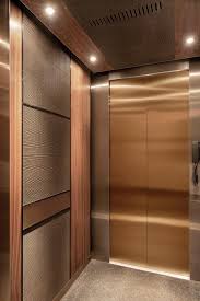 Levele 105 Elevator Interior With Customized Panel Layout Capture Panels In Bonded Bronze With Dark Patina And C Elevator Interior Elevator Design Lift Design