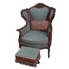 True to heritage, this armchair has sheltering wings curving gracefully down the sides to padded arms, a hand carved. Carved Victorian Style Wingback Armchair With Ottoman Ebth