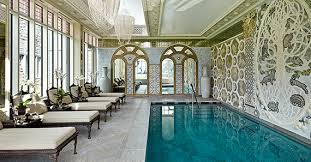 White and light grey interior pool with glass cathedral roof. Luxury Properties Indoor Pools Home Appraisals