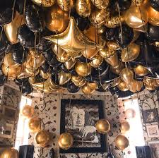 Gold chain black light dinner party. Balloon Ceiling Gold Theme Party Gold Party Black Party Decorations