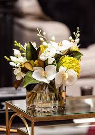 Simple coffee table centerpiece for living room decorating with flowers and candles. Beautiful Orchids For The Home Or Office White Flower Arrangements Flower Arrangements Floral Arrangements