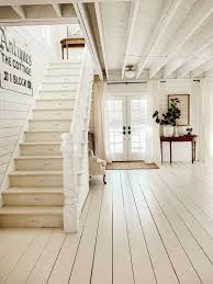 The space is light and airy with painted gray floors, all white walls, old rustic beams and headers, wood paneling, tongue and groove ceilings, dormers, vintage rattan. We Re Painted The Floors In 2020 White Painted Floors Painted Wood Floors Farmhouse Flooring