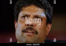 Former Indian cricketer Kapil Dev acknowledges the crowd during a grand  parade of India's former cricket captains during the first day of the  second test match between India and Bangladesh, in Kolkata,
