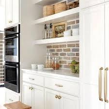 White shaker cabinets have daylight spotlight and it looks more luminous. White Brick Backsplash Design Ideas