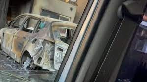 It shows a car gutted by flames in the drive and the home blackened by ther. Y9bq0eg Nahonm
