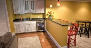Neutral basement features a sectional and wood accents. 33 Inspiring Basement Remodeling Ideas Homemydesign Small Basement Kitchen Basement Remodeling Basement Decor