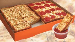 The pizza emerges, fully baked, on the other side, where a second robot arm transfers it to a cutting board, slices it into six pieces, places it in a pizza box, and closes the box. Little Caesars Brings Back The Box Set At A New Lower Price Chew Boom