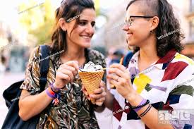 Lesbian couple holding ice cream cone while standing in city, Stock Photo,  Picture And Royalty Free Image. Pic. WES-DGOF01615 | agefotostock