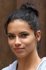If you're wondering what are the best highlights for olive skin tone, you should take a look at the shades worn by these celebs. Adriana Lima Wavy Dark Brown Bun Hairstyle Steal Her Style