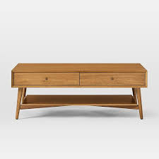 Lofted on airy steel legs, there is enough room to stow anything from magazines and remotes to pillows and throws. Mid Century Storage Coffee Table