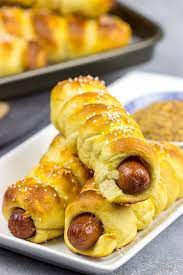 Serve with a variety of mustards or cheese sauce. Cheddar Pretzel Hot Dogs Wrapped In Soft Pretzel Dough And Cheese