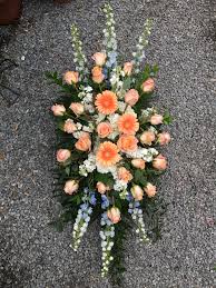 Florists in grand rapids mn love this funeral basket filled with vibrant colors of flowers to make their life made up of roses, spray roses, gerberas, alstroemeria and more in shades of red, orange, yellow, pink and. Evans Peach Blue Funeral Spray In Peabody Ma Evans Flowers