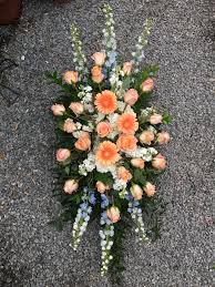 Burnt orange flowers are a perfect addition to wedding centerpieces and wedding bouquets, pairing wonderfully find dark orange flowers at fiftyflowers! Evans Peach Blue Funeral Spray In Peabody Ma Evans Flowers