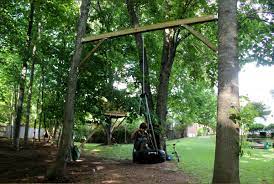For many people, tree swings are a comforting reminder of the joys of childhood. Tire Swing Between Two Trees Great Idea If You Don T Have A Long Sturdy Branch To Hang It From Backyard Swings Backyard Fort Outdoor