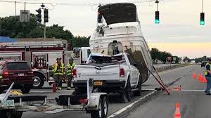boat breaks free crashes onto truck towing it officials say boat breaks free crashes onto truck