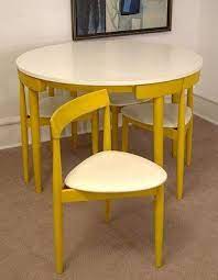 An Ingeniously Space Saving Midcentury Dining Table And Chairs The Curve Of The Chair Back Fits Pe Space Saving Dining Table Space Saving Furniture Furniture
