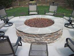 The elliptical steel wood burning fire pit is handcrafted with precision metalwork and inspired by casual sophistication and clean lines that set the stage for an outdoor ambiance that provides hours of warmth and an understated focal point in the garden, terrace, or veranda. A Perfect Large Gas Fire Pit With Coronado Ledge Stone By Archadeck Of Charlotte Gas Fire Pits Outdoor Outdoor Gas Fireplace Fire Pit Patio