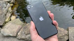Phone displaying little america tv show, held in landscape mode by pair of hands. Iphone Se 2020 Review The Best Cheap Iphone Tom S Guide