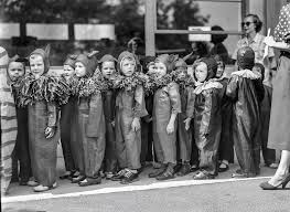 Since this is from thee same sett of negatives that the photos of the  little boy Mike are coming out of, I assume Mike is somewhere among these  boys, who appear costumed