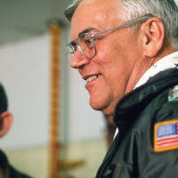 LGEN Arnold W. Braswell, commander, Pacific Air Forces, discusses the  progress of on-going projects with the non-commissioned officer-in-charge  of the engine shop, during a visit