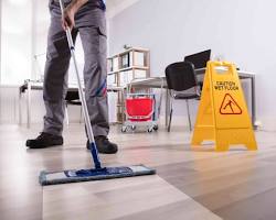 Office cleaners cleaning a floor