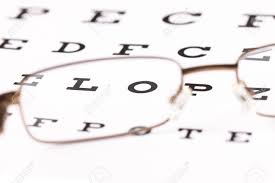 A Pair Of Reading Glasses Sitting On A Eye Test Chart With Only
