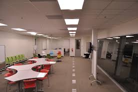 A Long View Of The Space With Chairs And Tables And One Lonely Fire Extinguisher Attached To The Wall Learning Spaces Johnson Space Center Space Design