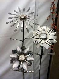 Flower made from faucet handle, washers, rubber and rebar. 1000 Metal Garden Art Ideas Will Amaze You