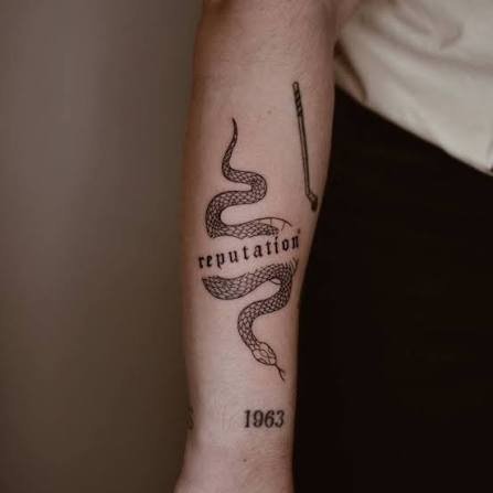 Word reputation and snake tattoo located on the