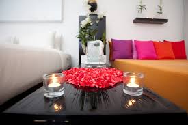 The fresh beauty of flower centerpieces can be enhanced by adding sand into glass jars or small pebbles to candles centerpieces. Romantic Room Decoration With Candles And Roses Novocom Top