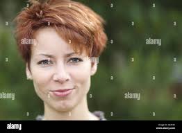 Portrait of a tomboyish young woman with red hair Stock Photo
