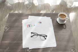 Office Table With Modern Glasses On Business Report Chart Paper