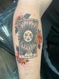 Sun tarot card tattoo inked on the back of the left arm. 55 Sun Tattoos That Brings Wisdom And Strength