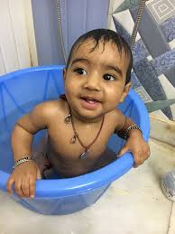 Little child in a bathtub, happy baby taking a bath playing. Baby Taking Bath Bath Time In Ear Headphones Baby Baby Face