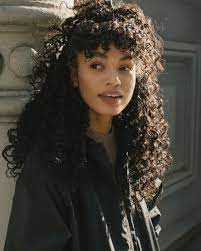 This haircut shifts the weight up, so that you gain volume on top, a lean silhouette along the bottom, and really open up the face. Curly Hair Fringe