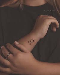 Purely decorative (with no specific meaning); Leo Zodiac Symbol Tattoo On Wrist