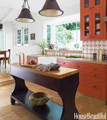 Glossy white cabinets stand out against the pumpkin orange walls. Burnt Orange Kitchen Burnt Orange Decor