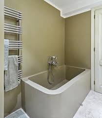 Young beautiful brunette woman takes a bath, watches a video on mobile phone. La Maliosa Natural Apartment Apartment Montemerano