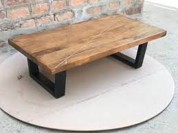 The round cyrano coffee table is inlaid with pie wedges of recycled reclaimed elm wood in different shades of natural brown. Rectangular Brass Inlay Wooden Coffee Table Size 51 27 18 Id 23256413733