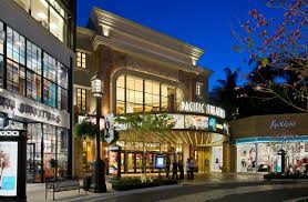 Shops, restaurants, stores and elegant residences around a central park with a fountain and trolley. The Americana At Brand Elkus Manfredi Architects
