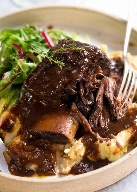 Bone-in braised short rib in red wine reduction, AI generated
