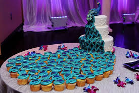 Love How The Peacock Feathers Cascade Into Cupcakes Peacock Cake Wedding Cakes With Cupcakes Cake