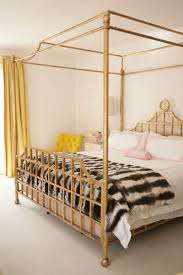 The gold metal sides of the canopy bed frame offer stability, while a center gold metal rail adds additional support, giving your little one a safe and beautiful place to rest her royal head at night. Gold Canopy Bed Contemporary Bedroom Cynthia Brooks Design Eclectic Bedroom Contemporary Bedroom Gold Canopy Bed