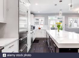 white cabinets, a dark wood island