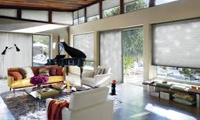 In this contemporary family room a fabric valance flanked by a pair of stationary panels frame the sliding door which opens out to the pool deck and garden. Window Treatments For Patio Sliding Glass Doors Hunter Douglas